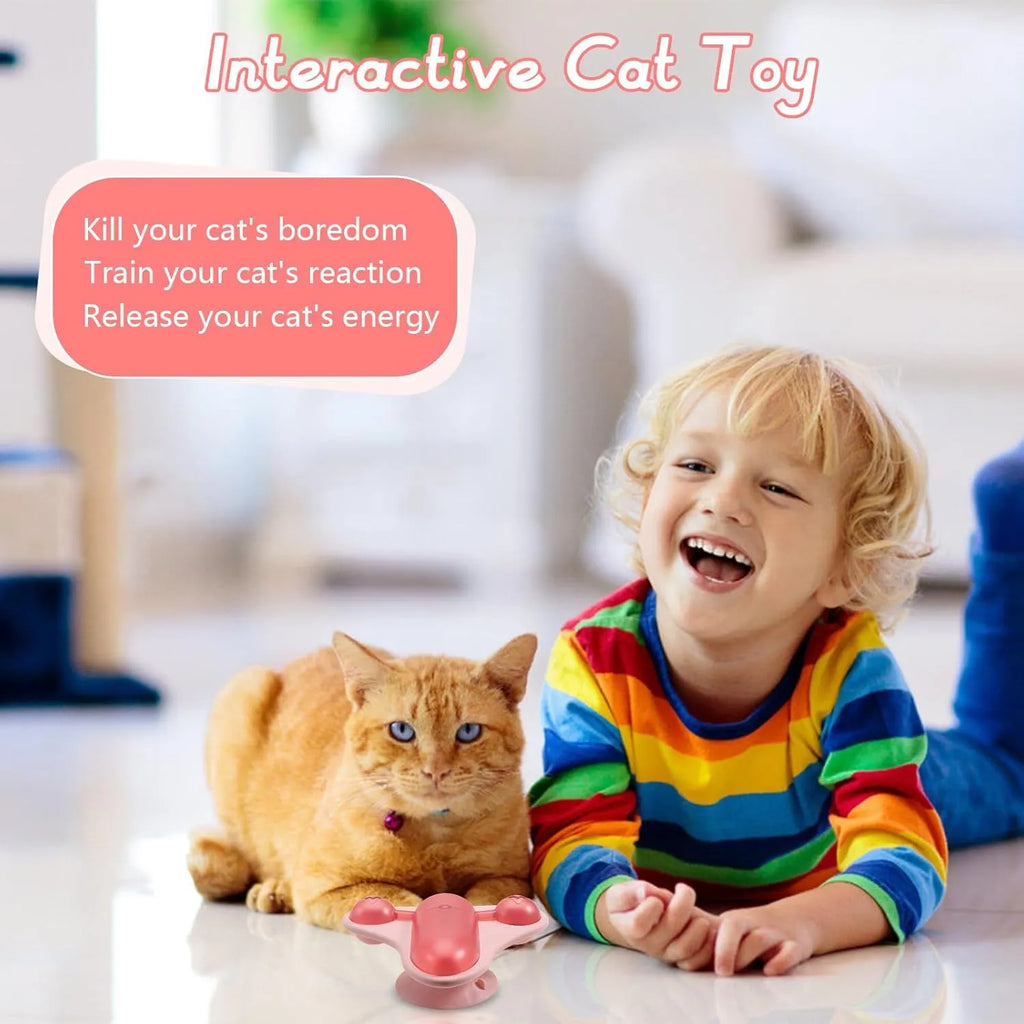 Blue interactive pet puzzle spinner toy with bell, catnip, and treat cabin on a smooth floor