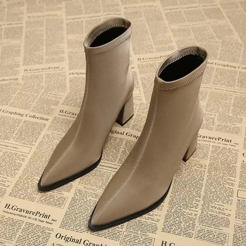 Women's khaki pointed-toe Martin boots with a wedge heel on a plain background.