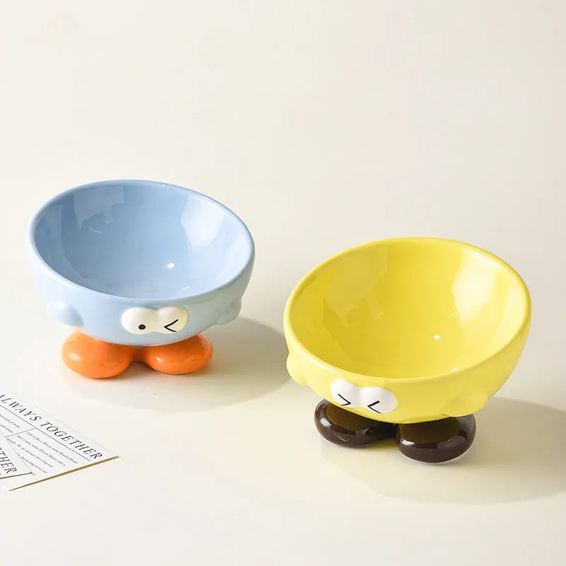 Blue slanted ceramic pet bowl with cute expression design for cat and dog cervical spine support