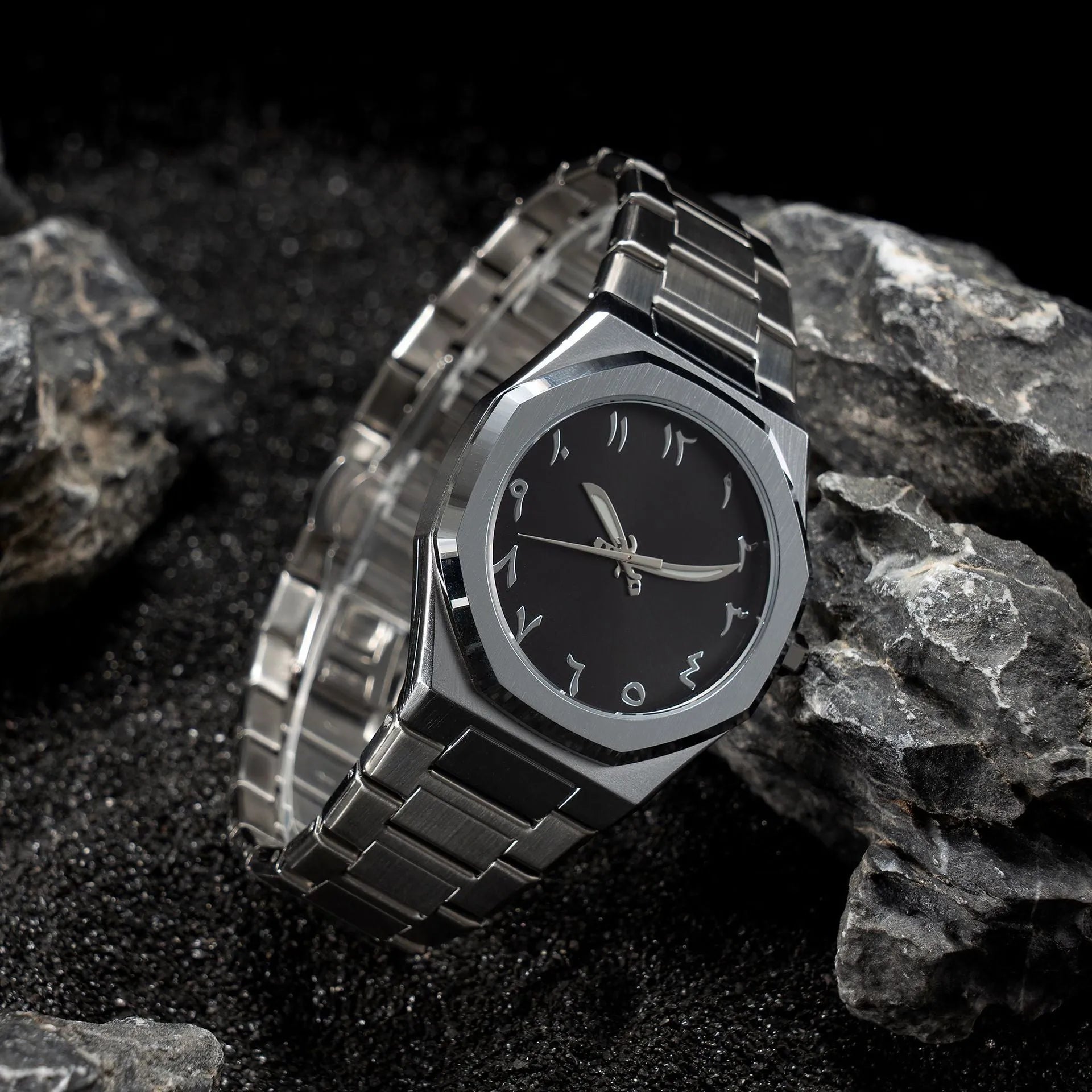 Men's silver and black business casual watch with steel bracelet and analogue dial on a wrist.