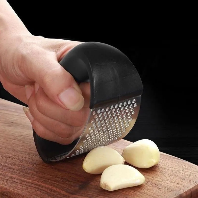 Stainless steel garlic press with ergonomic handle in available colours for kitchen use
