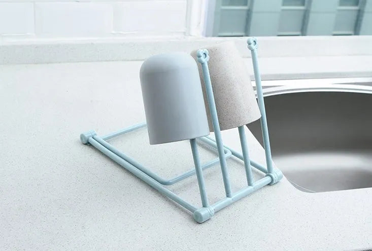 Light grey foldable plastic dishcloth shelf on a kitchen countertop