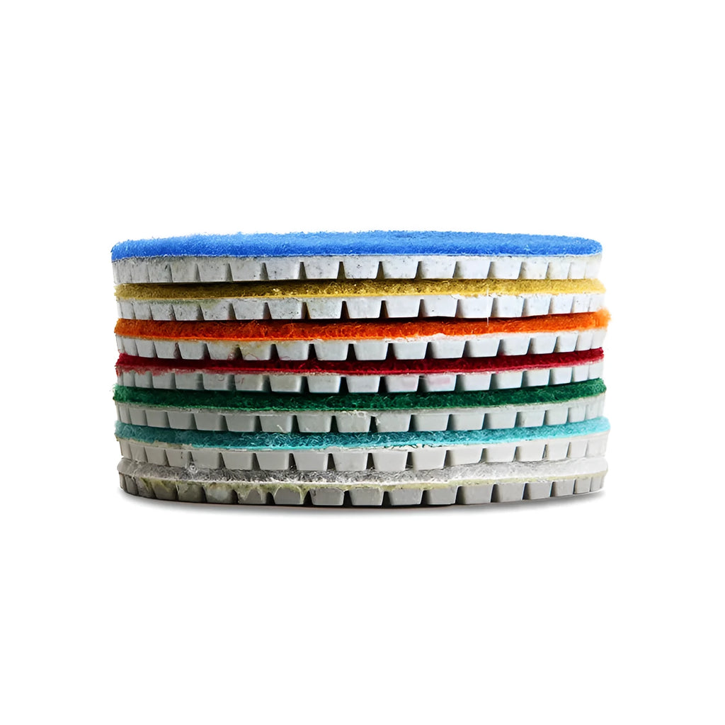 Set of 10 emery stone polishing discs with grits from 50 to 3000 mesh on a grey background.