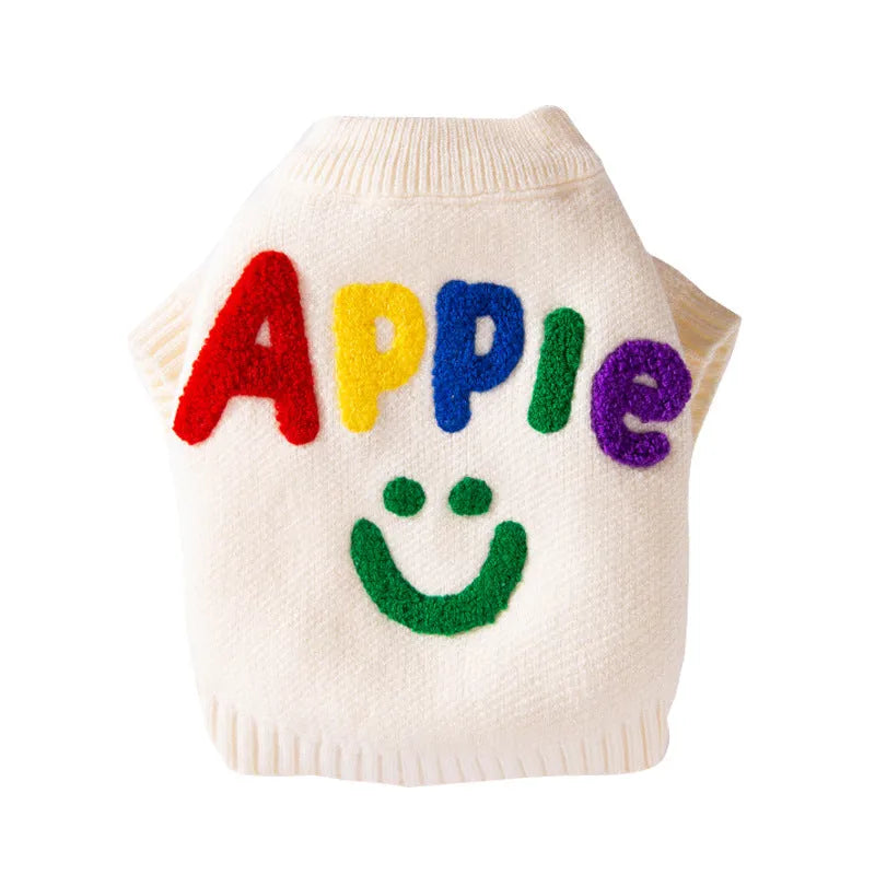 White knitted small dog sweater with rainbow Apple embroidery and green smiley face on a pet