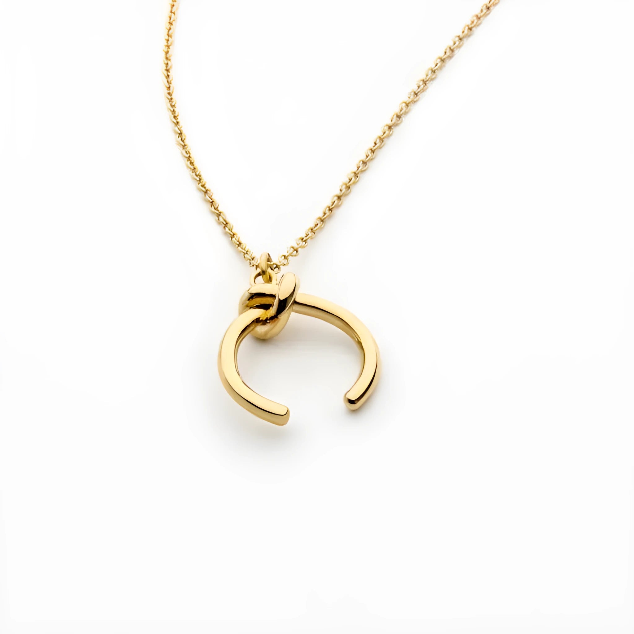 Geometric copper pendant necklace on an adjustable cross chain in a gold electroplated finish.
