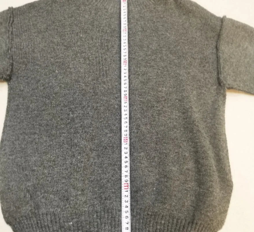 Women's grey side-slit acrylic sweater and matching trousers suit set.