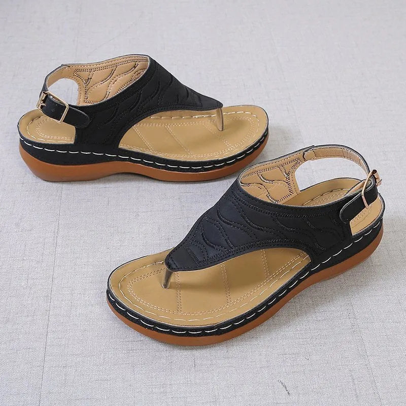 Women's black casual wedge heel sandals with an adjustable buckle strap on ankle.