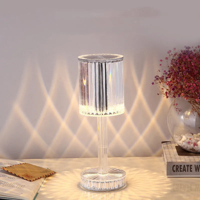 Modern crystal table lamp with a diamond-faceted shade on a metal stand, showing amber colour option.