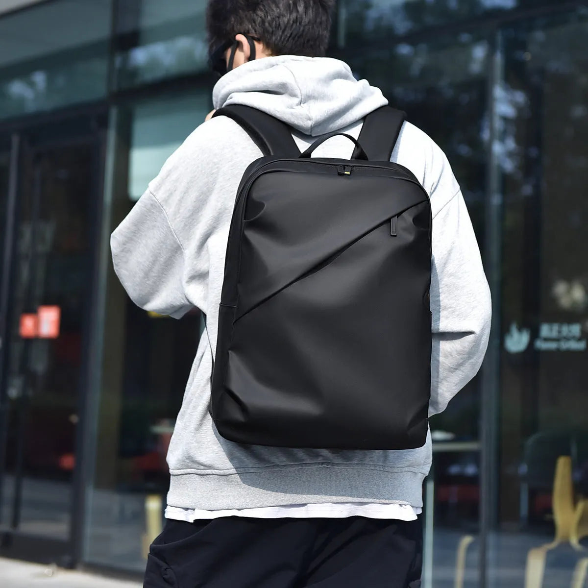 Large waterproof backpack in black, blue, or grey with PU leather construction and computer compartment
