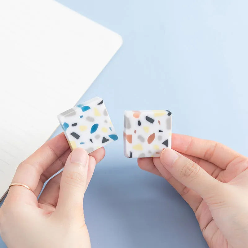 Small white PVC art eraser on a blue background showing its 36mm size.