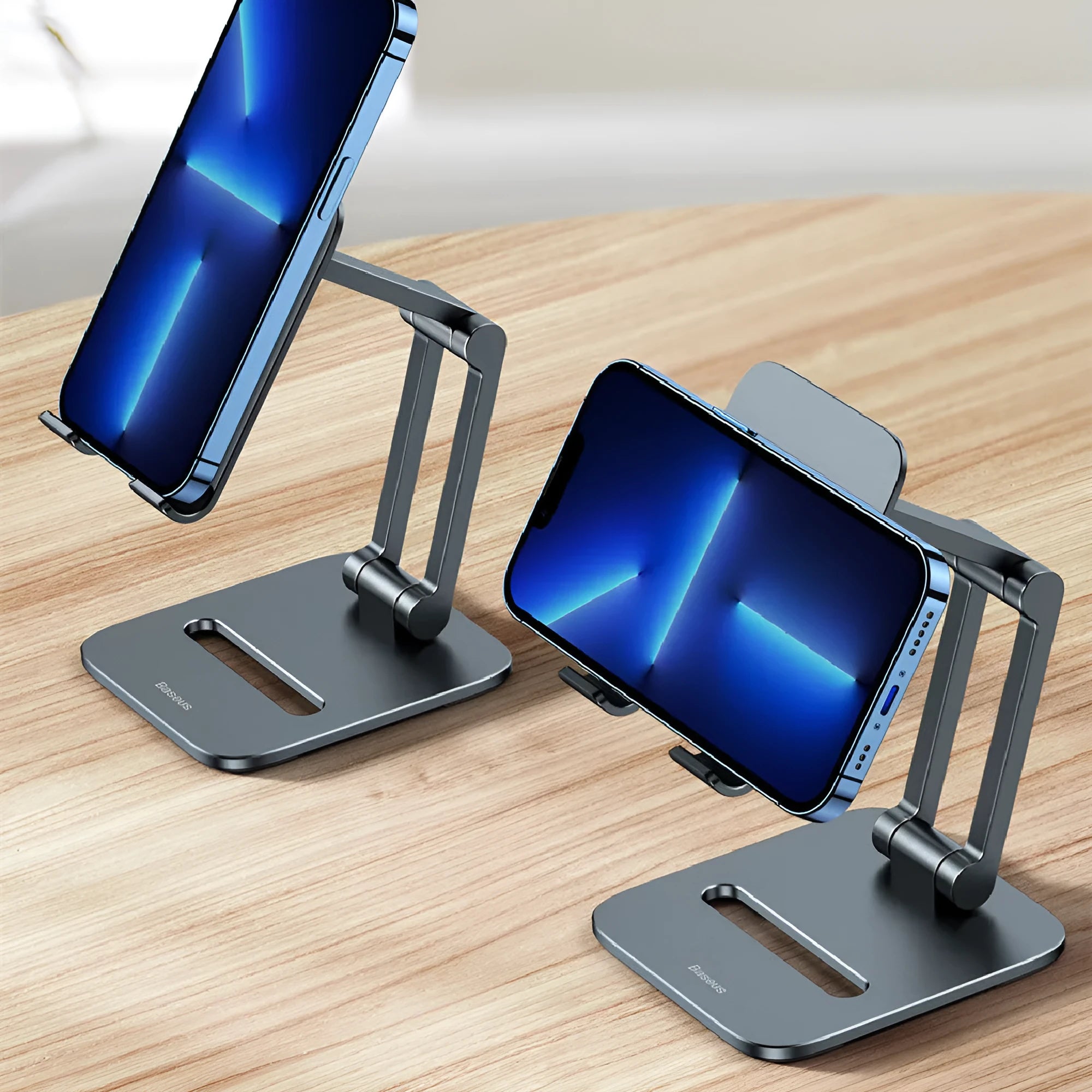 Deep space grey aluminium folding stand holding a tablet and a mobile phone separately.