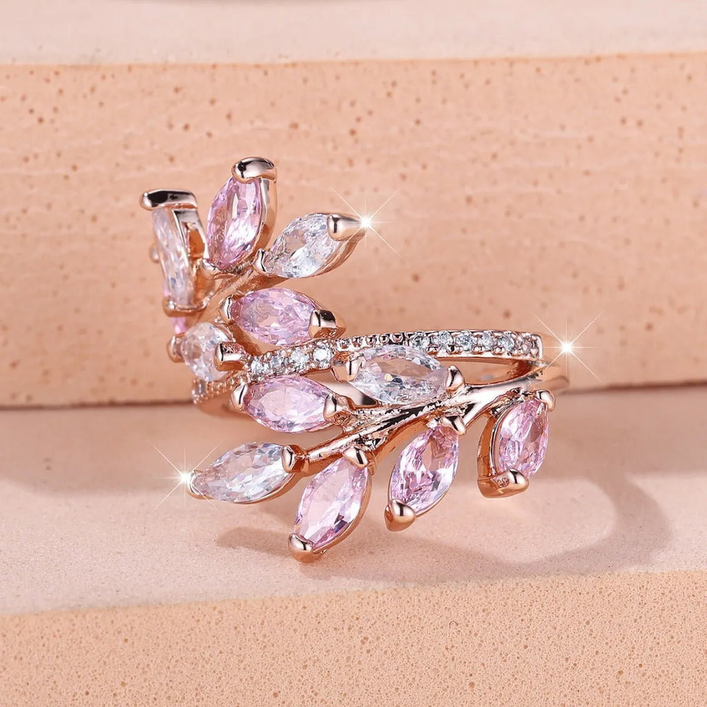 Close-up of an adjustable horse eye zircon leaf fashion ring in a rose gold finish with white stones.