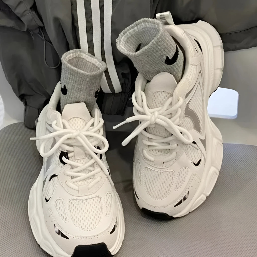 Beige mesh platform sports shoes with a wedge heel and front lace-up fastening.