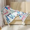 Bohemian style acrylic sofa cover blanket with tassel trim in a geometric pattern colour option.