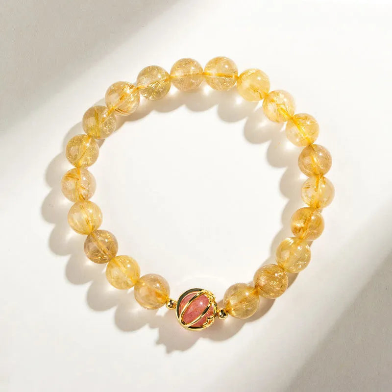 Gold rutilated quartz crystal bracelet with diamond-cut beads in 6mm and 8mm size options.
