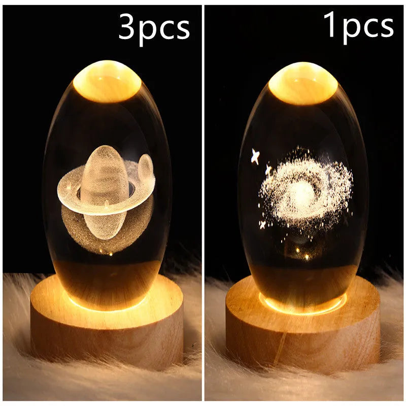 LED galaxy crystal ball night light with 3D planet designs on a table