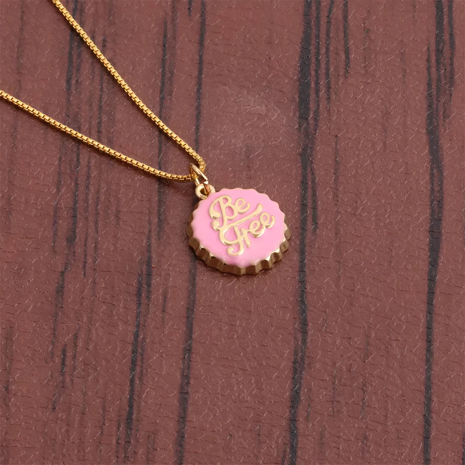 Gold plated bottle cap pendant on a copper chain necklace in multiple colour options.