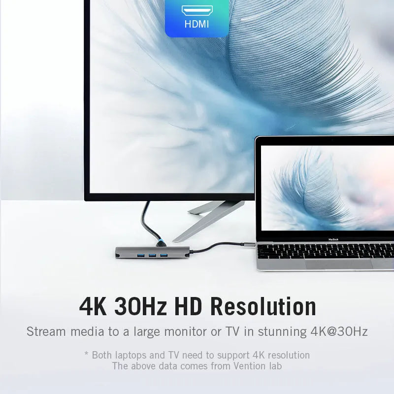 Deep grey USB-C to HDMI, Ethernet, and USB 3.0 multi-port hub on a desk.