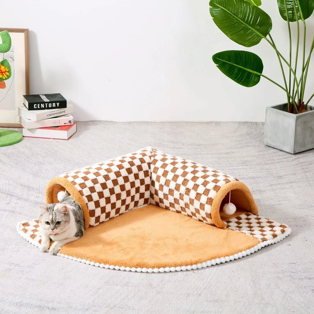 XL sized fan-shaped plush pet bed with an attached tunnel in coffee colour on a wooden floor.