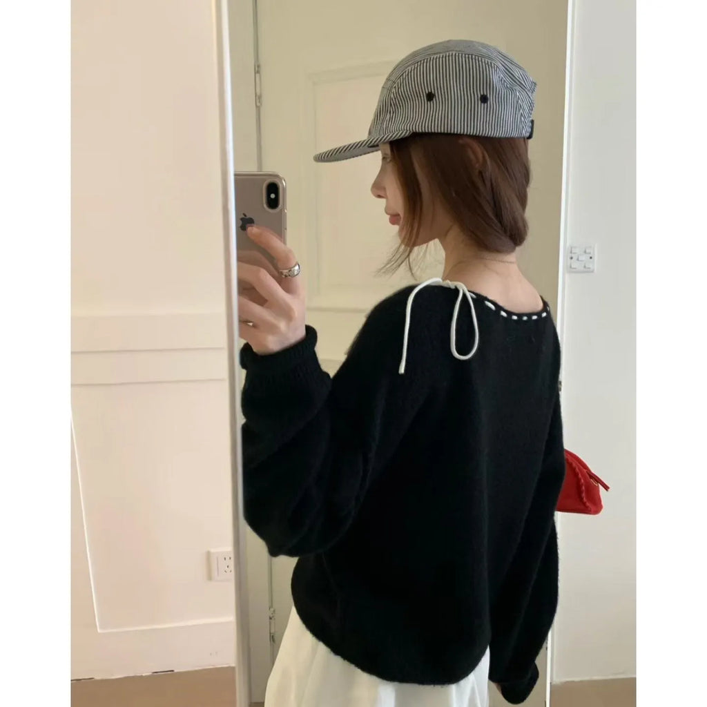 A grey women's loose-fitting pullover knit top made from regenerated cellulose fibre.