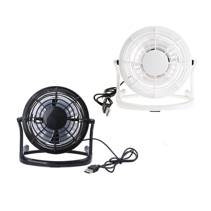Black mini USB desk fan with adjustable angle on a wooden desk.