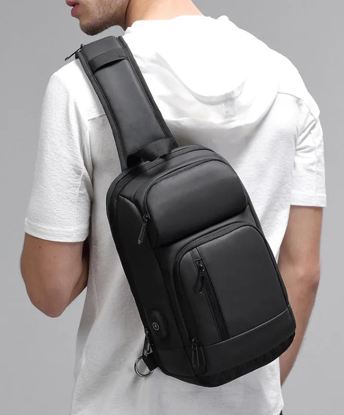 Black medium outdoor shoulder bag with air cushion strap showing internal laptop and organiser pockets