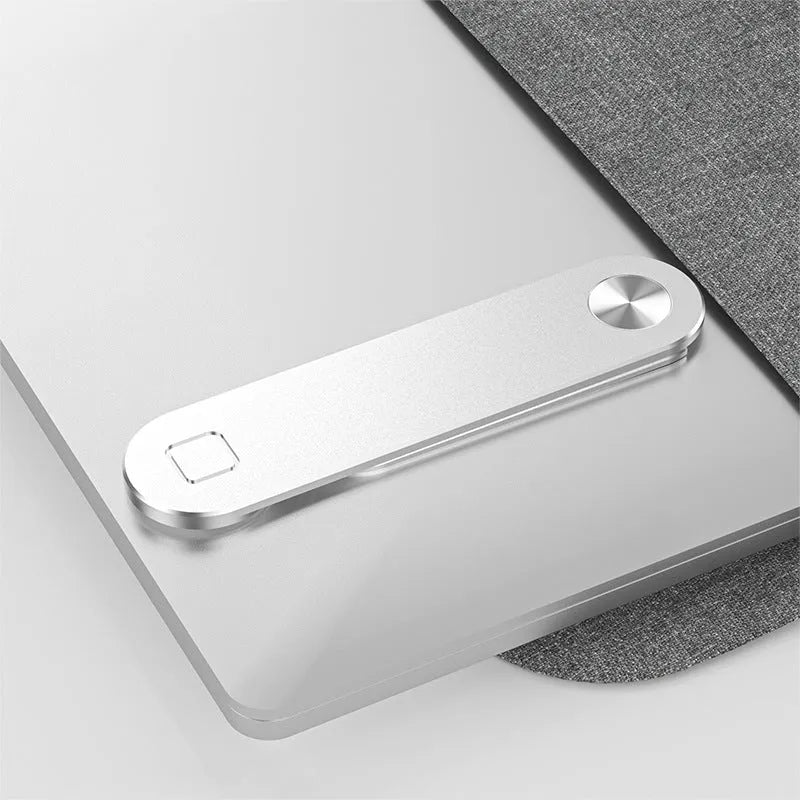 Black aluminium laptop phone holder with magnetic clip attached to a monitor, holding a smartphone