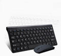 Black and white wireless keyboard and mouse set with USB receiver on a wooden desk.