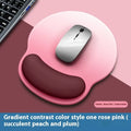 Silicone mouse mat with wrist support in gradient colour pattern on desk