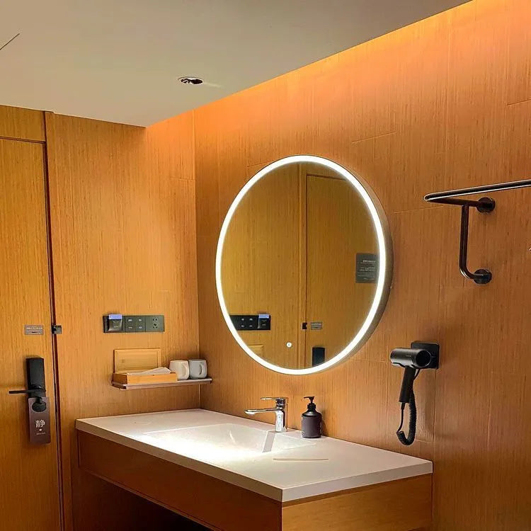 Round black aluminium alloy smart bathroom mirror with integrated LED lighting on a wall.
