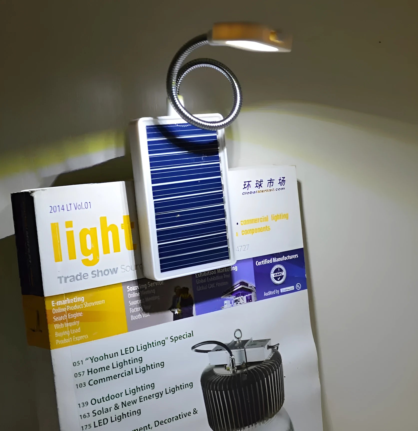 White outdoor solar lamp with plastic shade and solar panel on top.