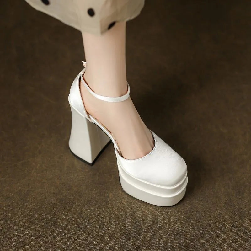 Women's white waterproof platform pumps with a chunky block heel and round toe on a neutral background.