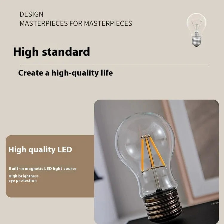 Creative small desktop night lamp with a suspension bulb and iron art body on a wood grain base.