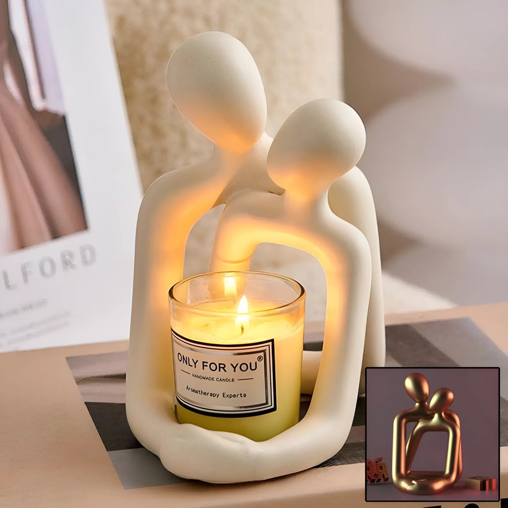 Modern minimalist loving couple resin statue in milky white on a wooden desk.