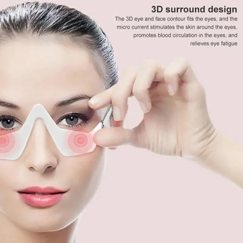 Pink and white 3D micro-current eye massager shaped like glasses on a grey background.