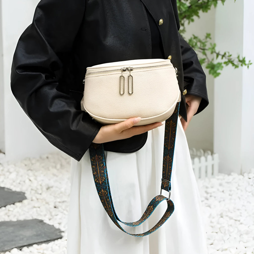 Women's soft PU leather messenger bag in saddle shape with adjustable strap and zippered compartment