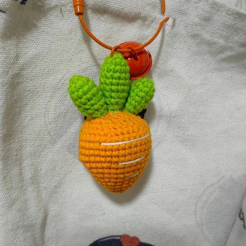 Wool cartoon carrot-shaped keychain pendant on a key ring.