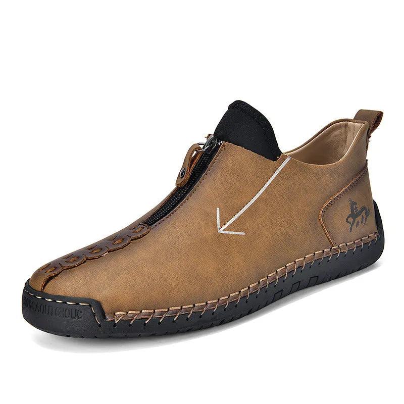 Men's brown leather-look zip-up ankle boots with hand-stitched detailing on a white background.