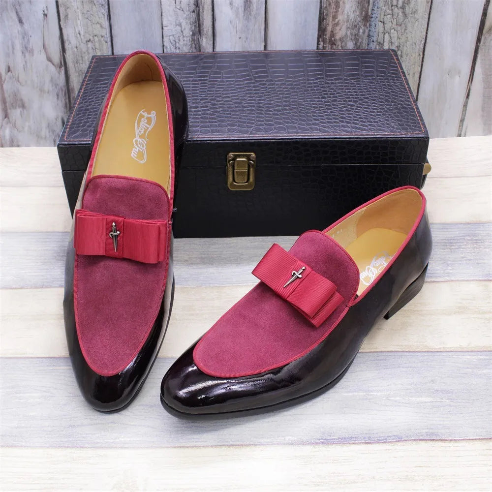 Men's glossy black patent leather low-top shoes featuring a gold tassel detail on a white background.