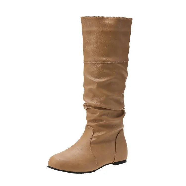 Women's flat knee-high slip-on boots in black with a round toe and rubber sole.