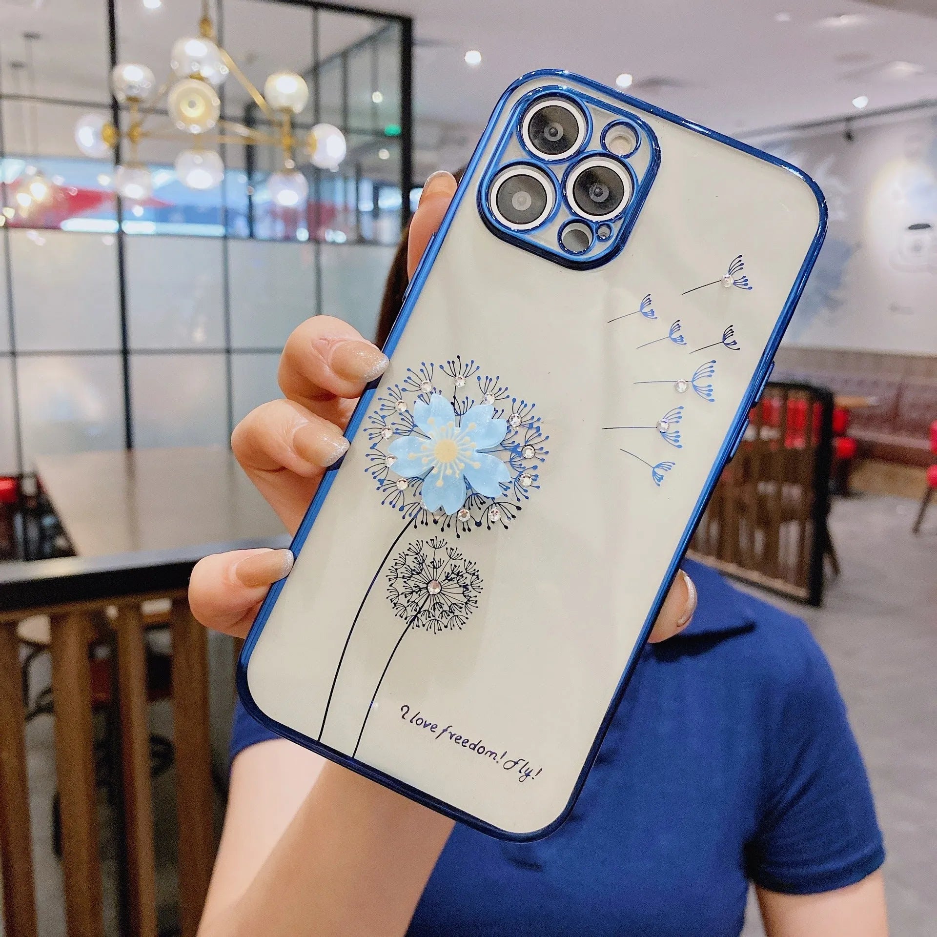 Green iPhone case with a 3D white flower design and a rotating stand on the back.