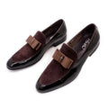 Men's glossy black patent leather low-top shoes featuring a gold tassel detail on a white background.
