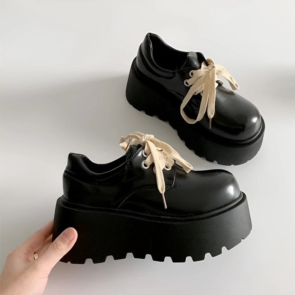 Matte black women's lace-up shoes with a high English muffin heel and thick rubber sole.