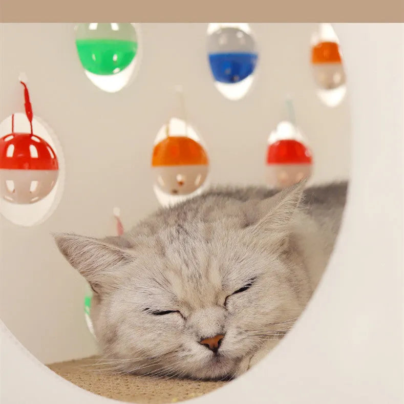 Plastic house-shaped cat scratch board with integrated bell ball toy for feline enrichment
