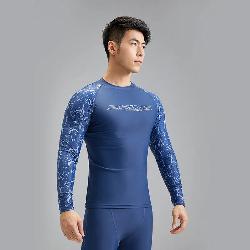 Men's dark blue nylon swimwear set with pattern detail showing swim top and trunks
