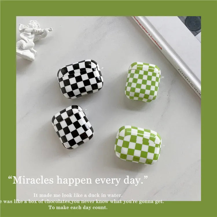 Black and green checkerboard patterned TPU protective case for Apple AirPods with optional lanyard and loop pendant attachments.