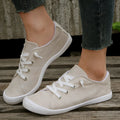 Women's creamy white fabric casual sneakers with low-top design and rubber sole