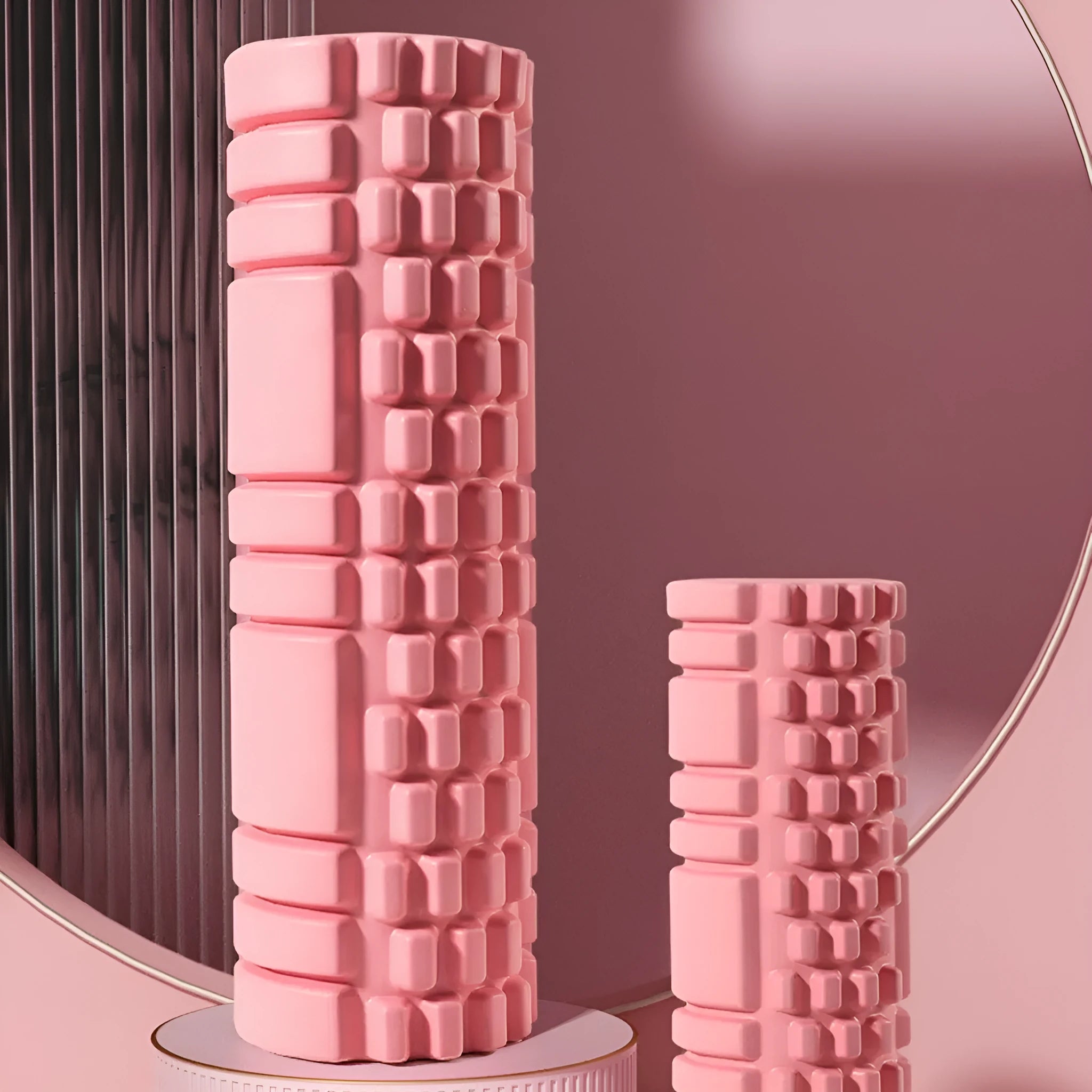 A firm EVA foam roller in a choice of colours like pink or black, shown in different sizes for fitness recovery.
