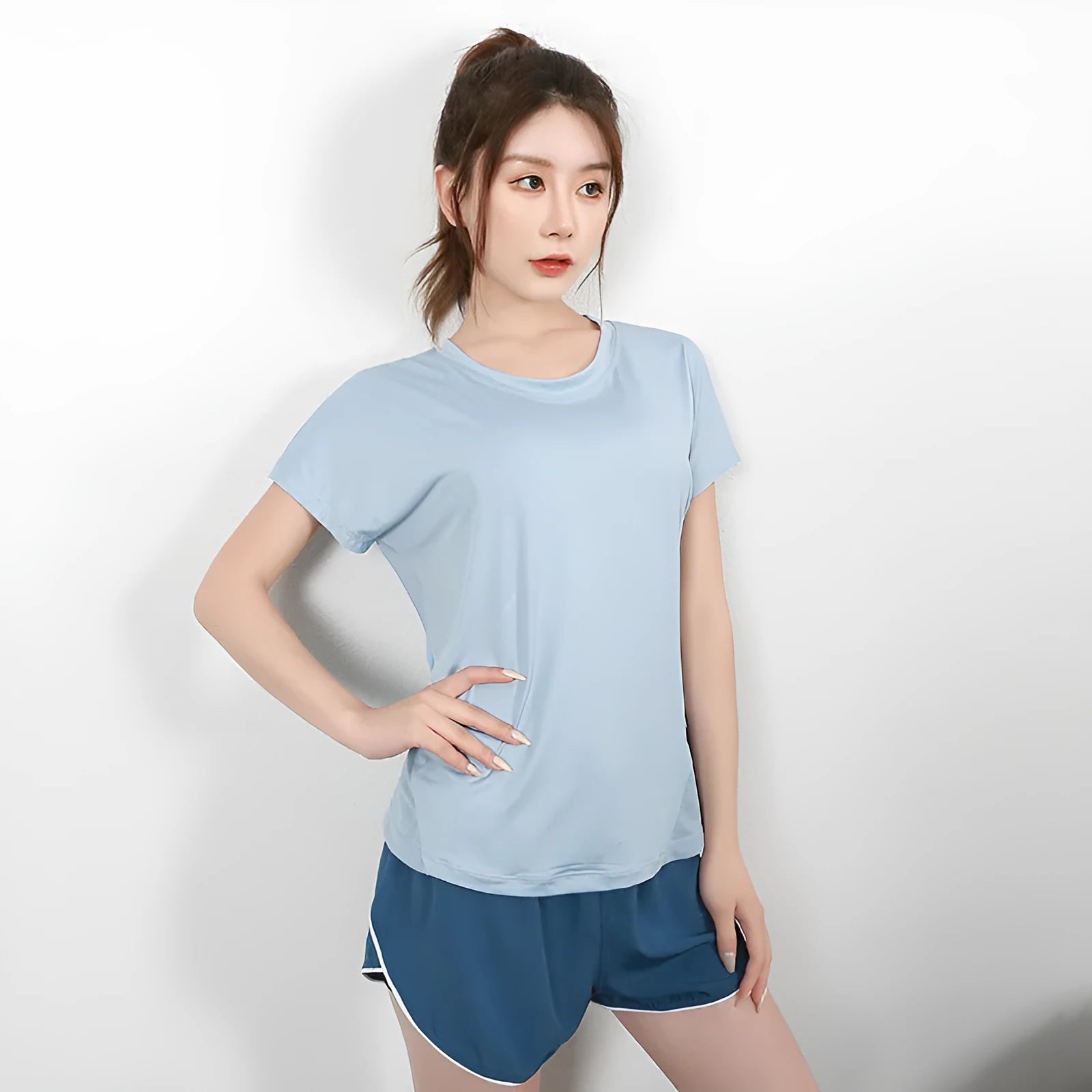 Women's short sleeve polyester sports t-shirt in pink, shown for running and fitness.