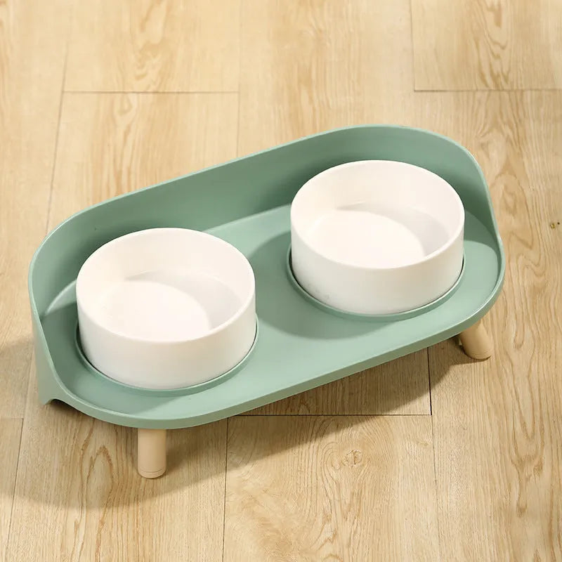 Green adjustable tilted double pet food bowl with spill-proof edges for cat and dog feeding